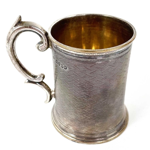 17 - A Victorian silver Christening mug by William Horton. With engine turned decoration and C scroll han... 