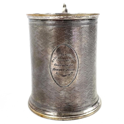 17 - A Victorian silver Christening mug by William Horton. With engine turned decoration and C scroll han... 