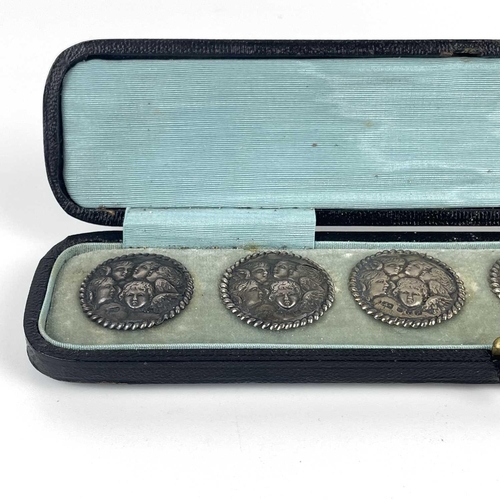 308 - A Victorian silver set of six buttons. By Levi & Salaman, embossed with angels heads after Reynolds,... 