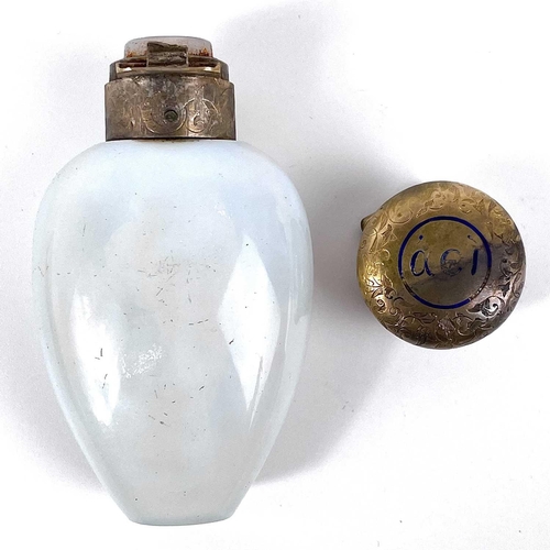 312 - A Victorian opaline glass scent bottle with silver gilt and enamel hinged lid. The lid with foliate ... 