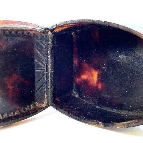 313 - A Georgian tortoiseshell silver inlaid oval snuff box. The hinged lid with silver thumbpiece and hin... 