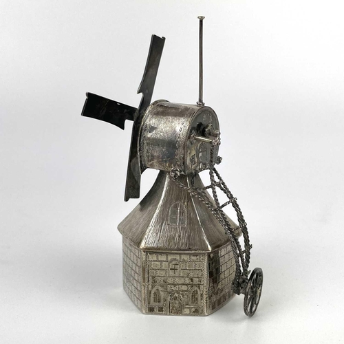 321 - A novelty white metal windmill, height 12cm, 121g. Together with a white metal circular pill box and... 