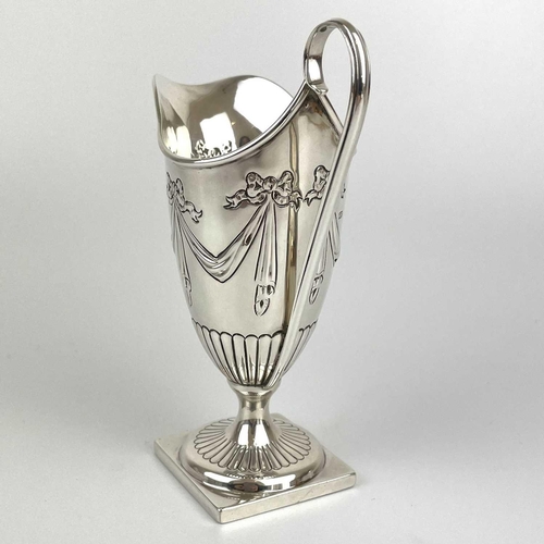 38 - A Victorian silver Adam style pedestal cream jug by George Fricker. Embossed with ribbon bow swags, ... 