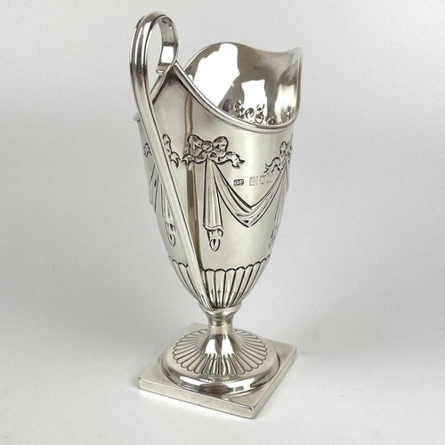 38 - A Victorian silver Adam style pedestal cream jug by George Fricker. Embossed with ribbon bow swags, ... 