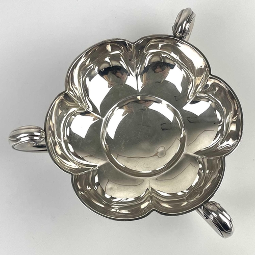 50 - An Edwardian silver lobed triple handled dish by Mappin & Webb. With flying scroll handles on ball f... 