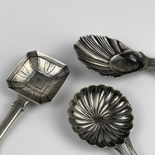 57 - A George V silver caddy spoon with shell bowl and two continental silver caddy spoons. The Georgian ... 