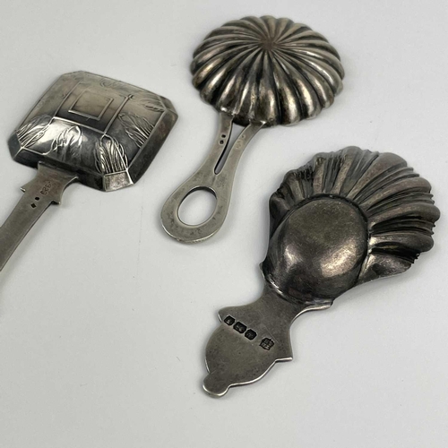 57 - A George V silver caddy spoon with shell bowl and two continental silver caddy spoons. The Georgian ... 