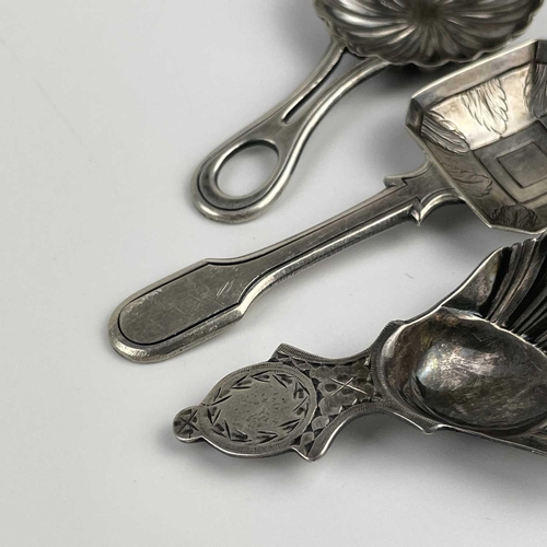 57 - A George V silver caddy spoon with shell bowl and two continental silver caddy spoons. The Georgian ... 