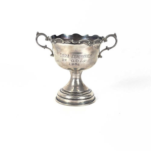 64 - A Columbian 0.900 silver trophy and a cup. The twin handled trophy with C scroll cast rim, stamped 0... 