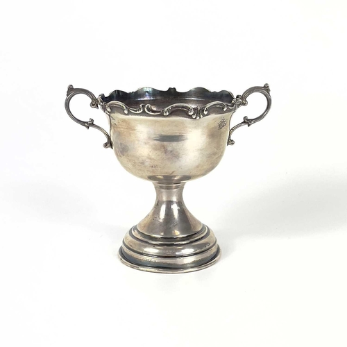 64 - A Columbian 0.900 silver trophy and a cup. The twin handled trophy with C scroll cast rim, stamped 0... 