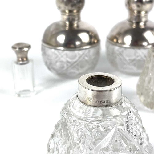 73 - A pair of George V silver mounted cut glass ovoid scent bottles. London 1920, height 11cm; together ... 