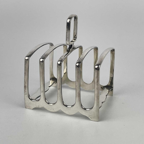 78 - A George VI silver four division toast rack, Sheffield 1949. Together with a pair of hinge lidded mu... 