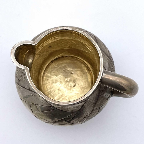 85 - A rare Imperial Russian silver and parcel gilt trompe l'oeil cream jug by Arseny Yakovlevich Sokolov... 