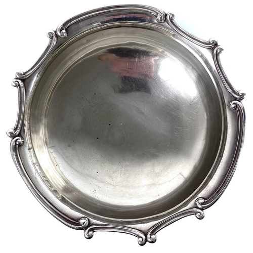 92 - An Edwardian silver large punch bowl. By Williams Ltd, Birmingham 1910, the rim cast with C scrolls,... 