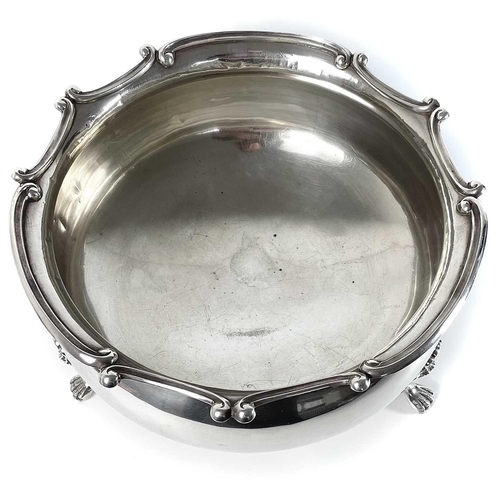 92 - An Edwardian silver large punch bowl. By Williams Ltd, Birmingham 1910, the rim cast with C scrolls,... 