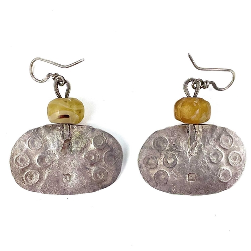 196 - Guy ROYLE (1954) Earrings  A pair of oval silver drop earrings each with a carved yellow stone bead.... 