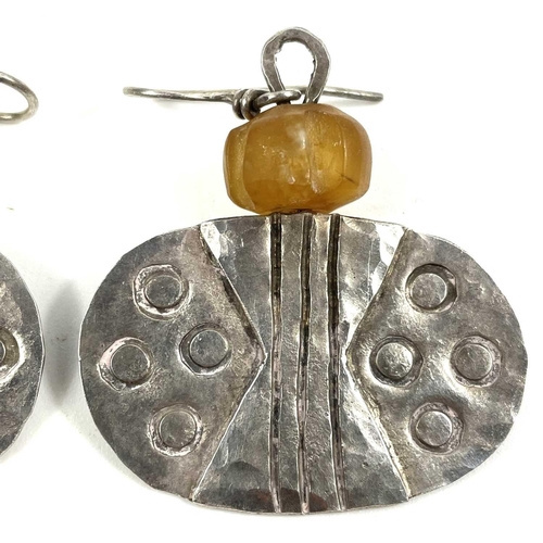 196 - Guy ROYLE (1954) Earrings  A pair of oval silver drop earrings each with a carved yellow stone bead.... 