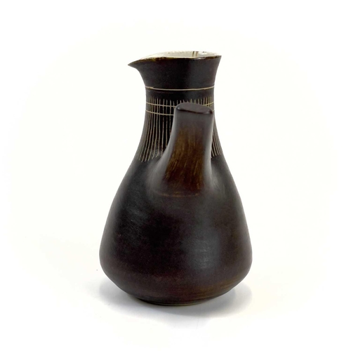 451 - Lucie RIE (1902-1995) Milk Jug, circa 1960 With manganese glaze and sgraffito decoration, and pulled... 