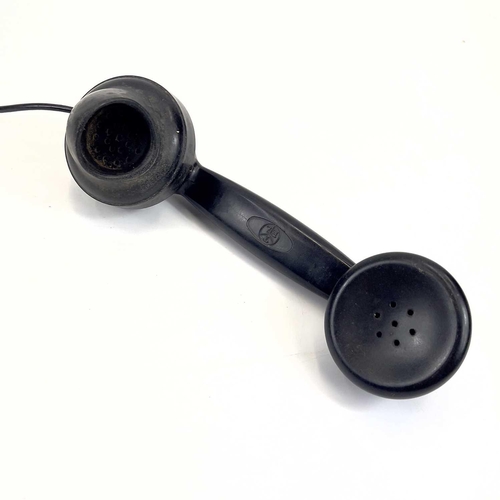 112 - An AEP black Bakelite telephone. Dated 1957, length 19cm.