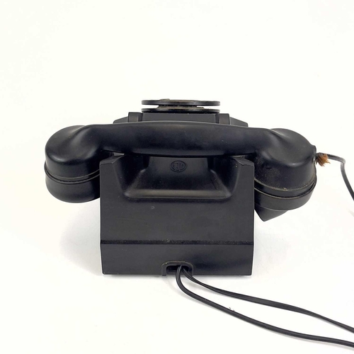 112 - An AEP black Bakelite telephone. Dated 1957, length 19cm.