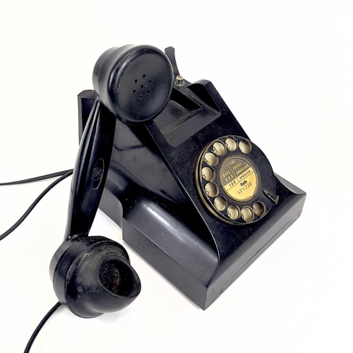 112 - An AEP black Bakelite telephone. Dated 1957, length 19cm.