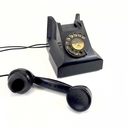 112 - An AEP black Bakelite telephone. Dated 1957, length 19cm.