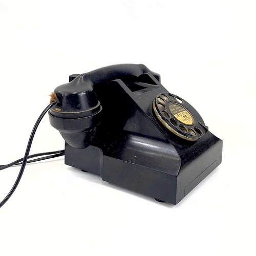 112 - An AEP black Bakelite telephone. Dated 1957, length 19cm.