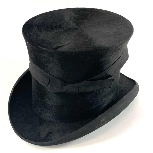 113 - A Victorian silk top hat and leather case. Labelled 15, overall width 33cm.