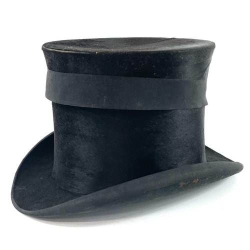 113 - A Victorian silk top hat and leather case. Labelled 15, overall width 33cm.