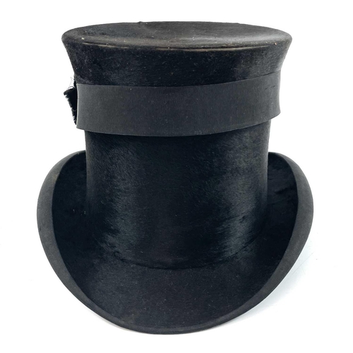 113 - A Victorian silk top hat and leather case. Labelled 15, overall width 33cm.