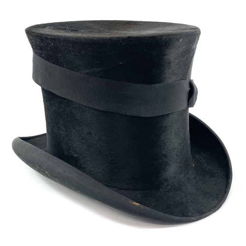 113 - A Victorian silk top hat and leather case. Labelled 15, overall width 33cm.