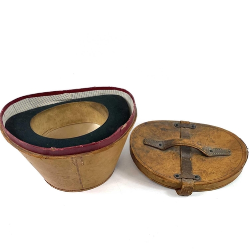 113 - A Victorian silk top hat and leather case. Labelled 15, overall width 33cm.