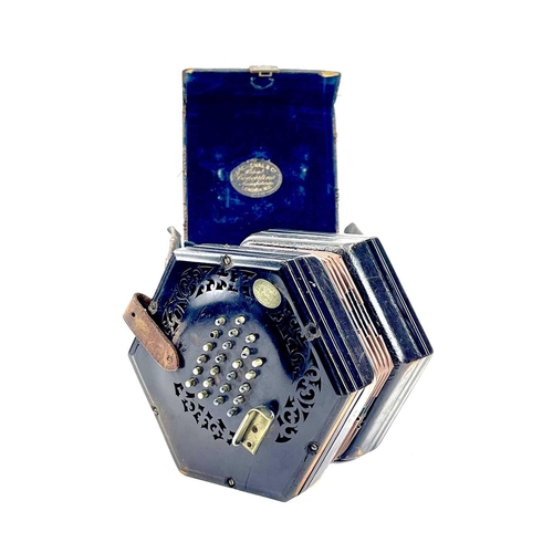 12 - A Lachenal 48 button concertina. Numbered 48857, with pierced ebony ends and nickel buttons, contain... 