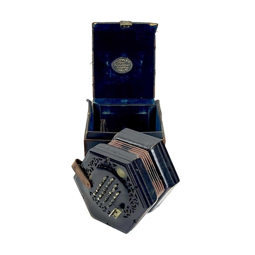 12 - A Lachenal 48 button concertina. Numbered 48857, with pierced ebony ends and nickel buttons, contain... 