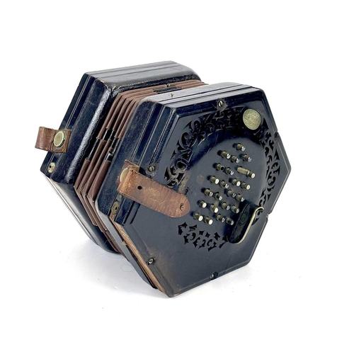 12 - A Lachenal 48 button concertina. Numbered 48857, with pierced ebony ends and nickel buttons, contain... 