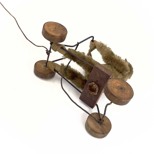 13 - A 1930s plush monkey on a cart probably Steiff. With wrought iron frame and wood seat and wheels, le... 