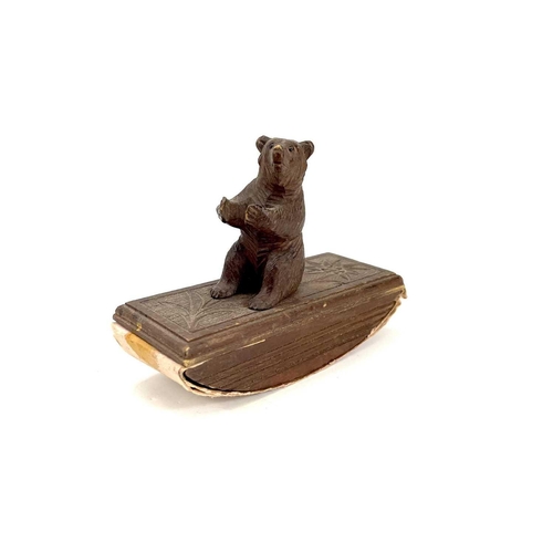 134 - A Black Forest carved blotter surmounted by a seated bear. Height 10cm. Together with a late19th/ear... 