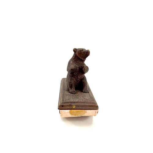 134 - A Black Forest carved blotter surmounted by a seated bear. Height 10cm. Together with a late19th/ear... 