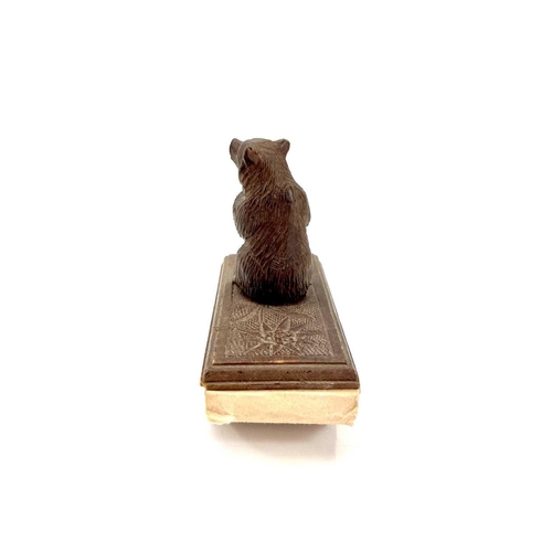 134 - A Black Forest carved blotter surmounted by a seated bear. Height 10cm. Together with a late19th/ear... 