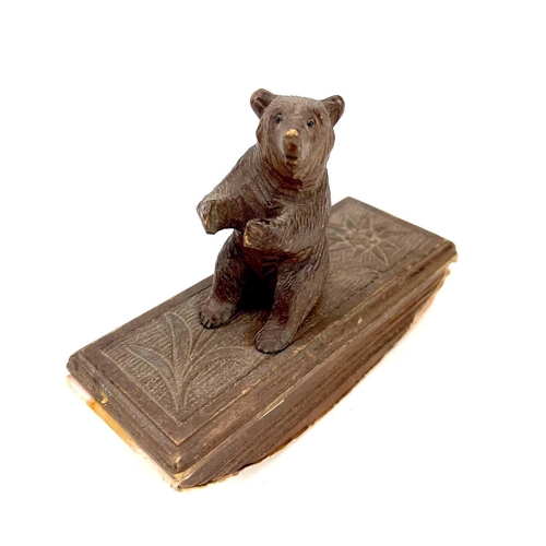 134 - A Black Forest carved blotter surmounted by a seated bear. Height 10cm. Together with a late19th/ear... 