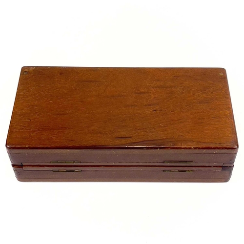 14 - A mahogany folding travel chess set. Circa 1900, fitted with red stained and natural bone pieces, wi... 