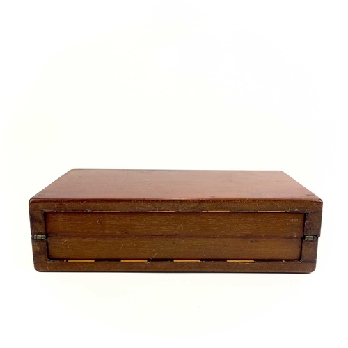 14 - A mahogany folding travel chess set. Circa 1900, fitted with red stained and natural bone pieces, wi... 