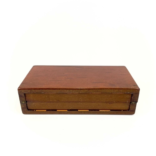 14 - A mahogany folding travel chess set. Circa 1900, fitted with red stained and natural bone pieces, wi... 