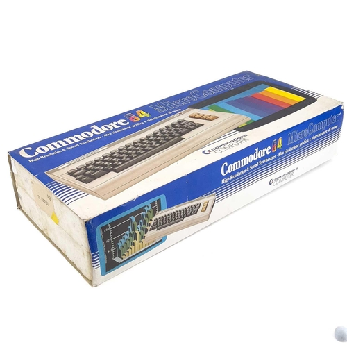 143 - A commodore 64 microcomputer. Boxed, with joystick, cassette player and instructions.