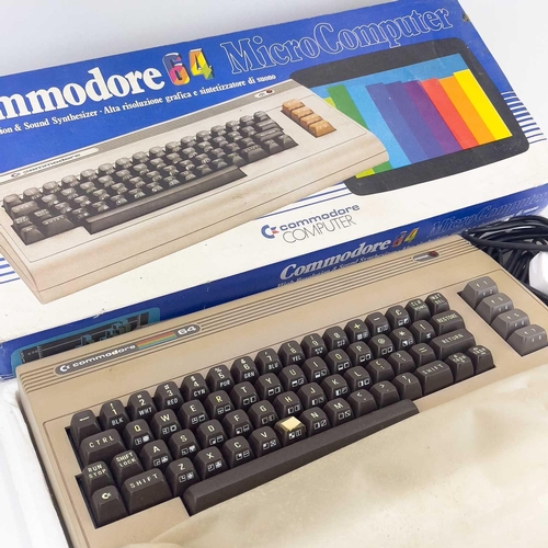 143 - A commodore 64 microcomputer. Boxed, with joystick, cassette player and instructions.