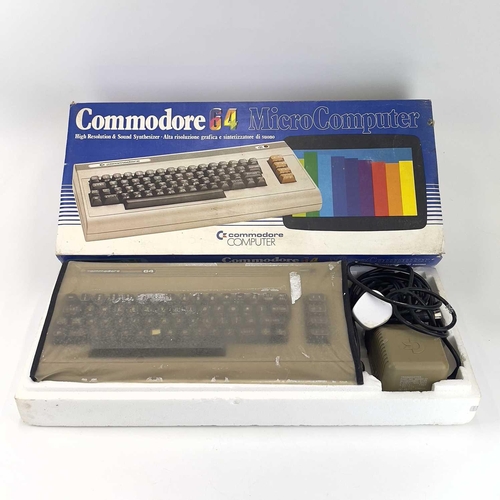 143 - A commodore 64 microcomputer. Boxed, with joystick, cassette player and instructions.