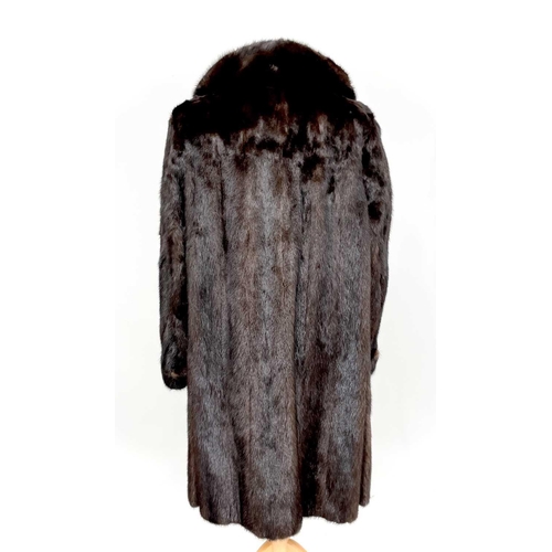 1605 - A Black Diamond 3/4 length mink fur coat. Together with a mink shawl. (2)There are no condition issu... 