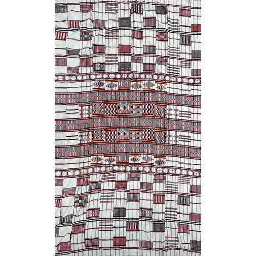 1611 - A cotton African textile with geometric designs. 135cm x 230cm, together with two other African text... 