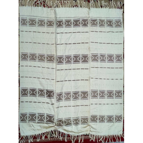 1611 - A cotton African textile with geometric designs. 135cm x 230cm, together with two other African text... 