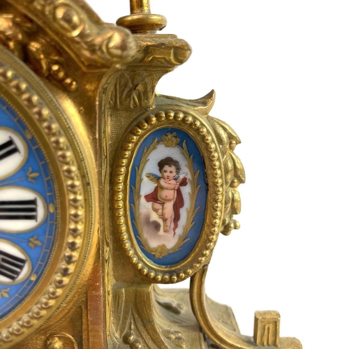 1705 - A French gilt spelter mantel clock. 19th century, with turquoise Paris porcelain mounts including ch... 